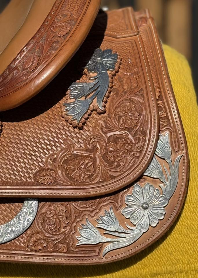 Bob's Custom 16 Tan — skirt corner silver and floral tooling close-up